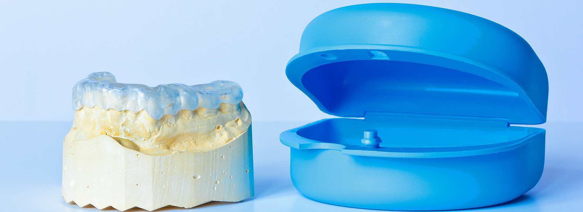 The image shows two dental implants, one intact and one broken, placed side by side against a white background.